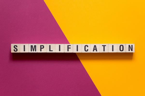 the word simplification with pink and yellow background