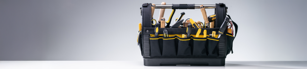 Image shows a black tool carrier filled with hand tools