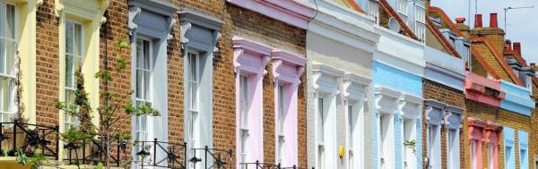 Row of terraced houses with balconies and brightly coloured window surrounds