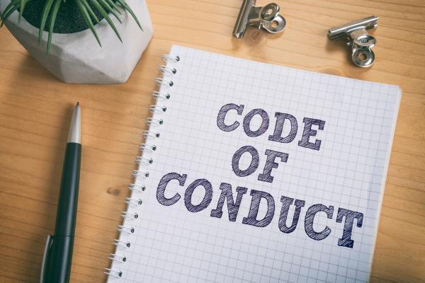 Notepad with code of conduct written on the front
