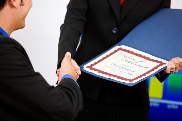 Someone handing over a certificate