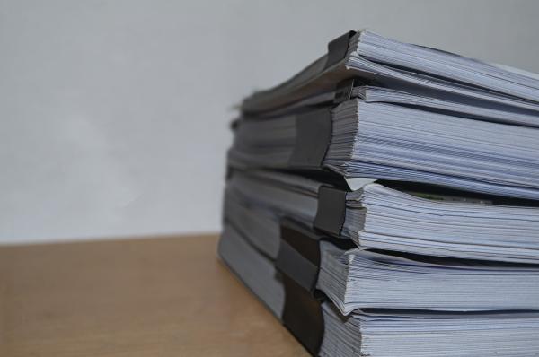 Stack of papers clipped together in bundles on a desk