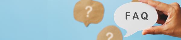 Hand holding a speech bubble with the acronym FAQ inside, surrounded by other speech bubbles with question marks