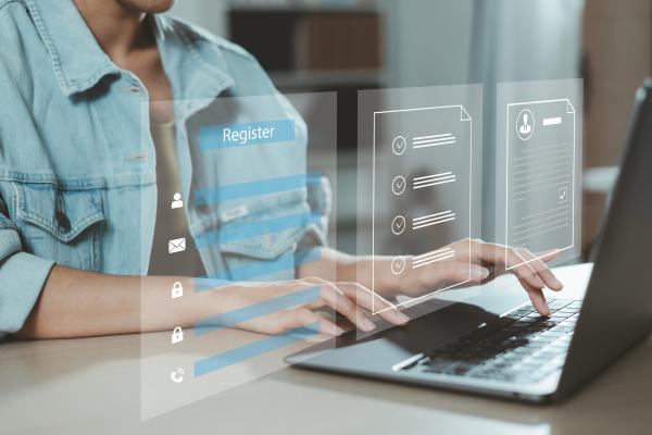 Person at a laptop completing a digital registration form