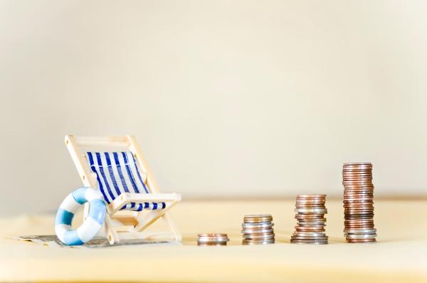 Striped deckchair with piles of coins next to it