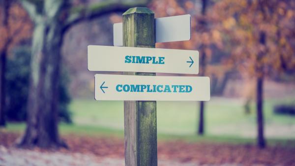 Signposts reading "simple" pointing right, and "complicated" pointing left