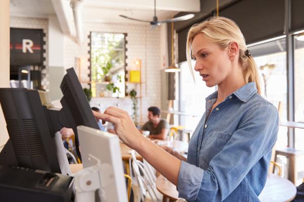 Waitress using electronic cash register