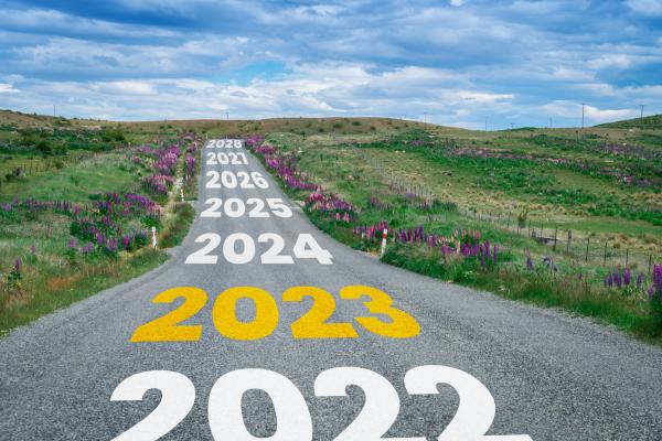 Years written across a country road with 2023 highlighted