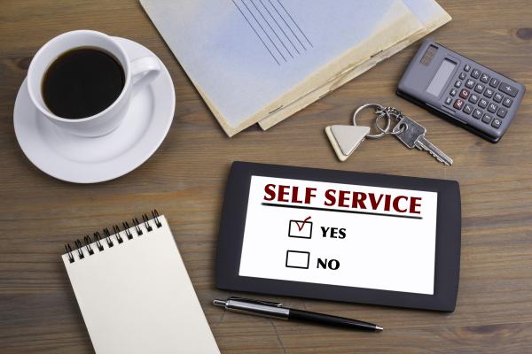 Notepad on table titled Self Service, with box ticked next to Yes and box next to No empty 