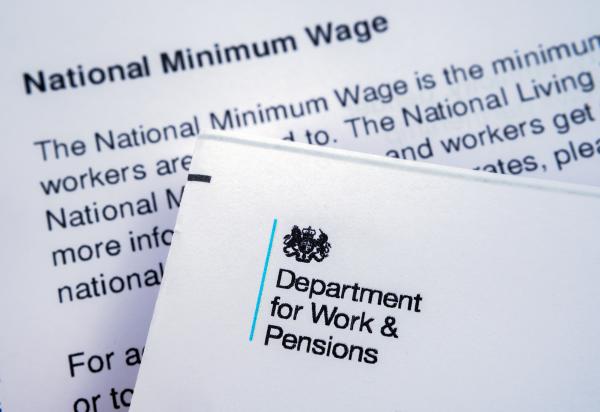 Department of Work and Pensions letterhead resting on another letter with heading "National Minimum Wage"