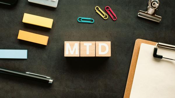letters MTD with clipboard and pen