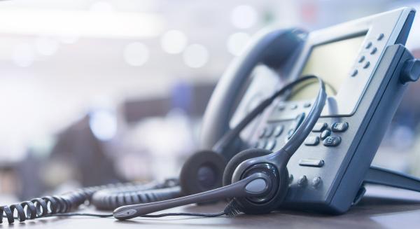 Telephone and headset on desk