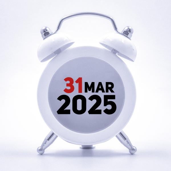 An old-fashioned alarm clock with bells either side of it has the words '31 March 2025' on the clock face, rather than numbers or hands.