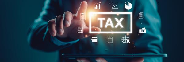 Man holding tablet computer horizontally with tax and other financial graphics projected above it