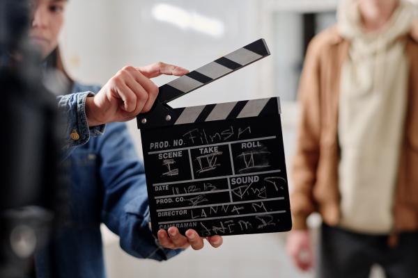 Woman holding film clapper 
