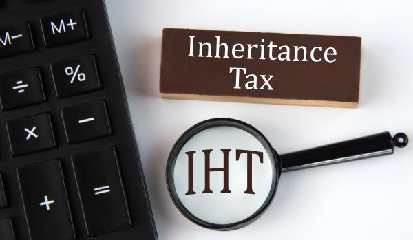 Calculator next to the words "Inheritance Tax" and a magnifying glass over the letters "IHT"