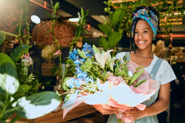 Florist holding large bouquet of flowers