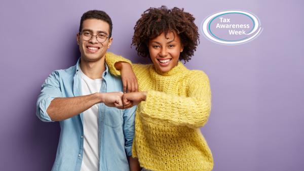 A diverse couple fistbumping and looking direct to camera, with the Tax Awareness Week logo