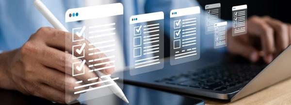 Close up of hands on laptop and holding pen with checklist icons overlaid