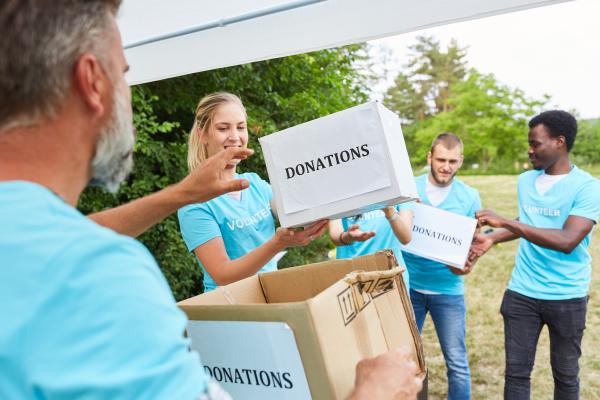 Image of volunteers distributing charity donations to those in need. 
