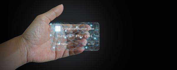 hand holding a translucent credit card sized ID