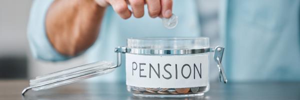 Image shows a person adding coins to a jar of money labelled pension