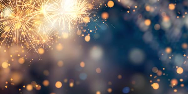 Fireworks and golden lights on dark night sky