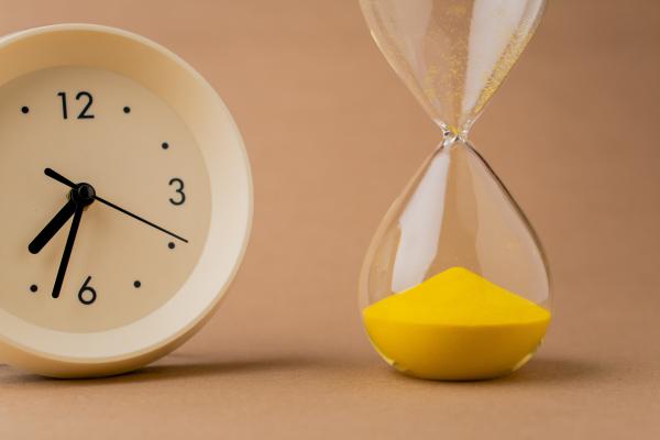 Picture of clock with hour glass showing time run out