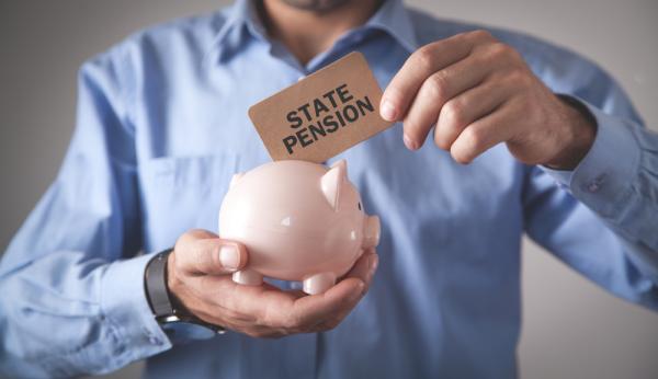 man holding piggy bank and posting state pension